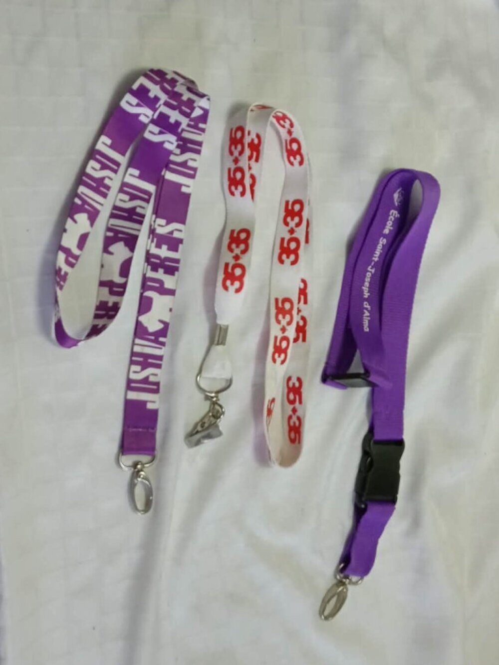Three identification straps/lineyards/idcords, including one by Joshua Perets